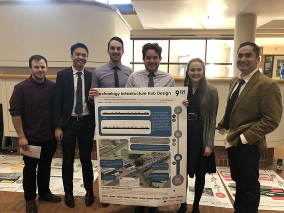 Dr. Fernando Burga, right, with students at the CAV poster session in December.
