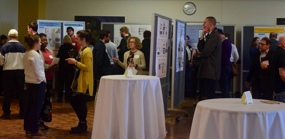 Faculty and students converse and view presentations at the 2019 End of Year Celebration