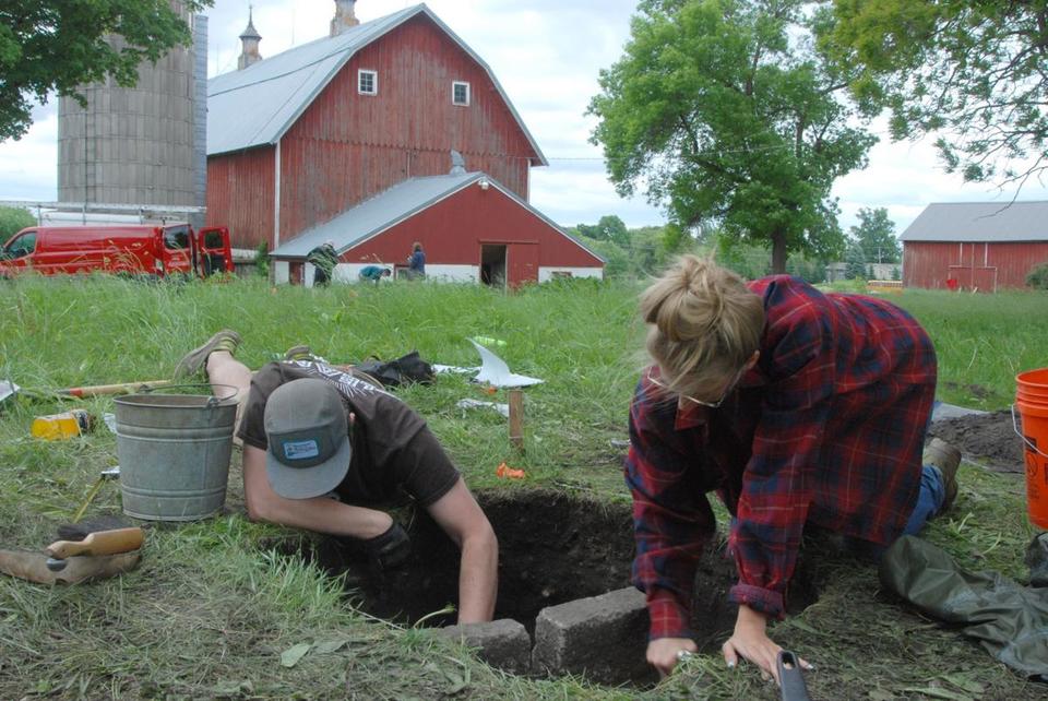 Earlier this summer, Nick Stilson and Mary Spencer investigate a foundation of a long-gone building at the historic Andrew Peterson Farmstead near Waconia. File photo by Mark W. Olson.