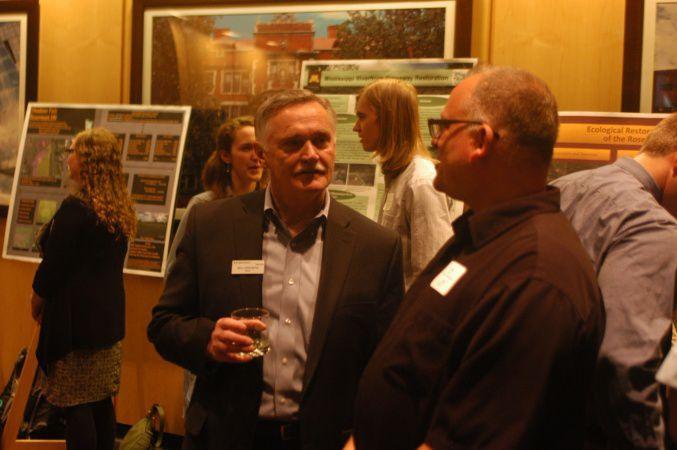 Rosemount Mayor Bill Droste talks with another attendee of Friday’s Resilient Communities Project end-of-the-year recognition ceremony at the University of Minnesota. (Photo by Tad Johnson)