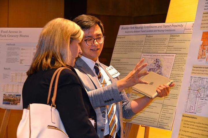A student explains his rcp project to an attendee