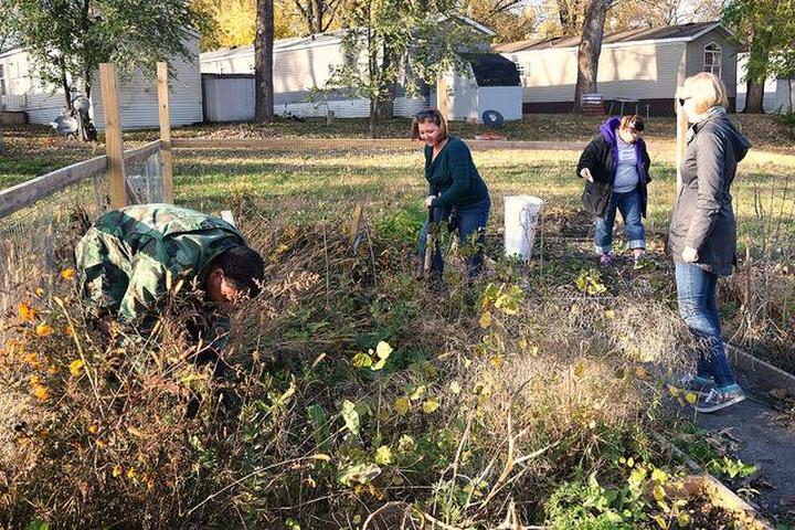 Carver County Health Specialist Tami LaGow and UMN School of Public Health student Sam Rosner help Riverview Terrace residents prepare their gardens for winter. The public health department piloted a community garden initiative in the mobile home park this year. Photo courtesy of Bridget Roby.
